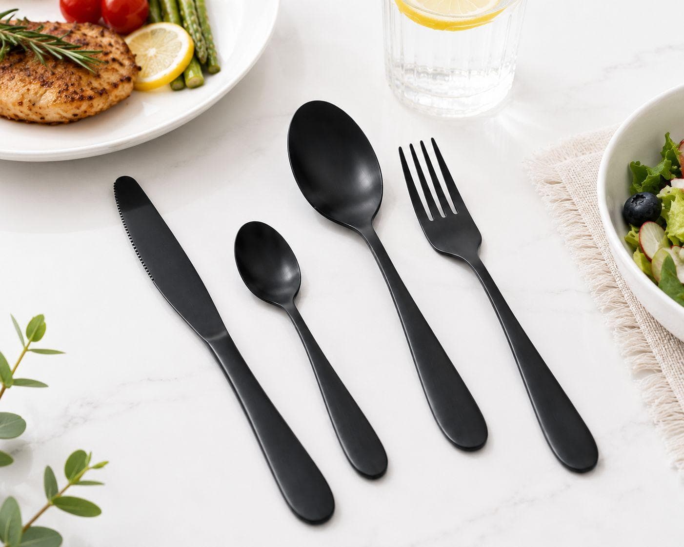16-piece black cutlery set with a simple design, suitable for everyday table use. 1