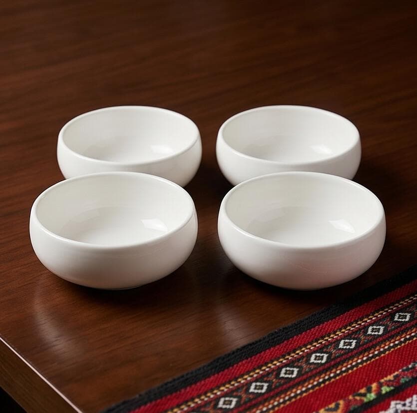 Small white ceramic bowl with a simple elegant design, ideal for sauces and appetizers. Size: 11.5 cm, durable and easy to clean.